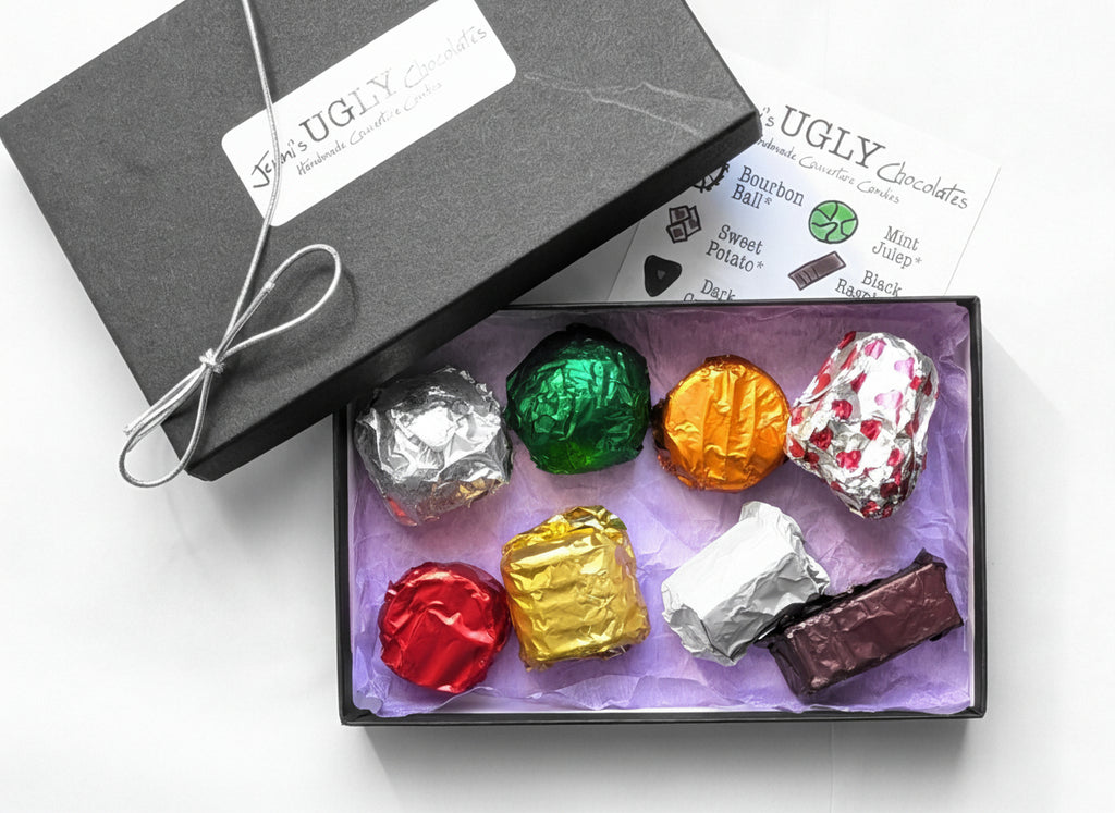 Box of colorful chocolate truffles with a 'UGLY' chocolates label on a white background